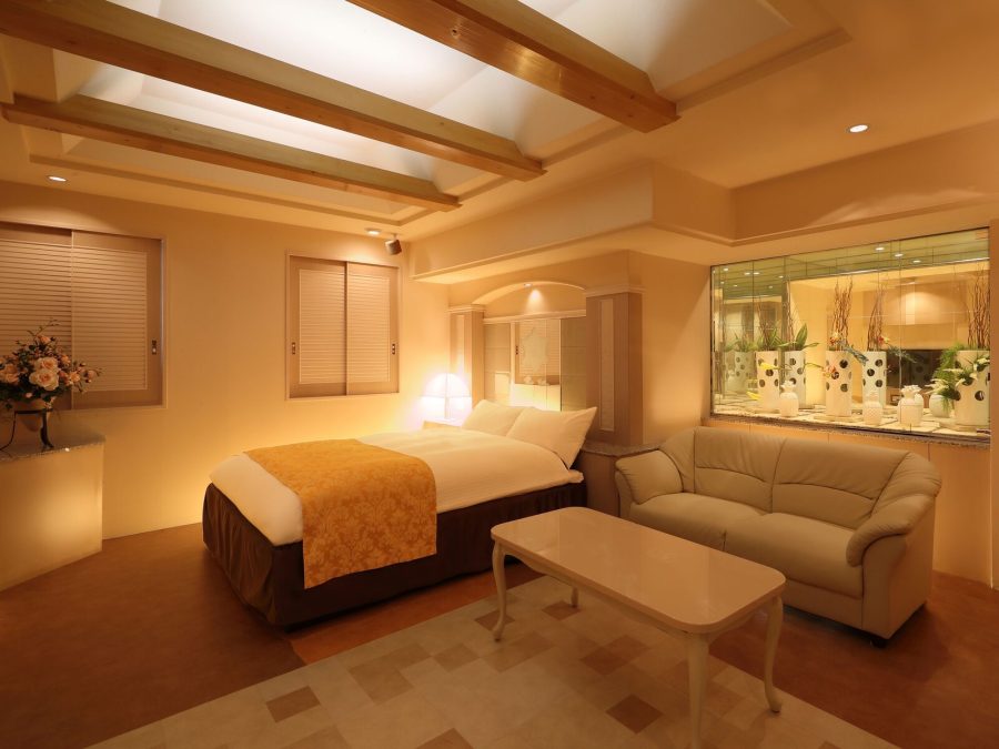 Bedroom at Hotel Fine Garden Umeda with a sofa, a low table and warm lighting
